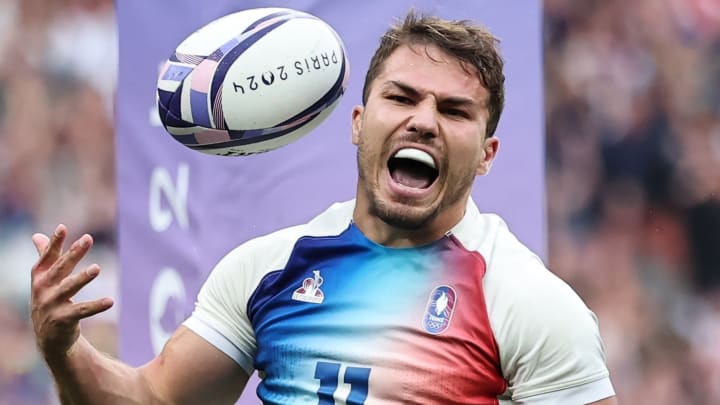 Antoine Dupont celebrates after leading France to a historic victory at the Stade de France