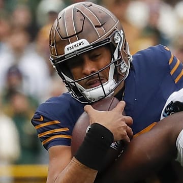 Green Bay Packers quarterback Jordan Love (10) is sacked by Carolina Panthers defensive tackle Tershawn Wharton.