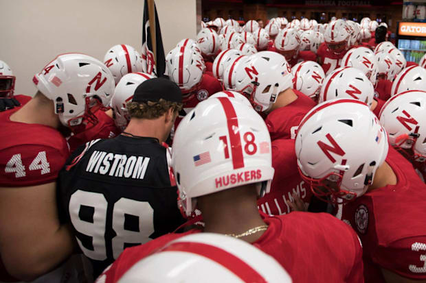 Former Husker Grant Wistrom huddles with the team before the Nebraska-Wisconsin game in 2017.