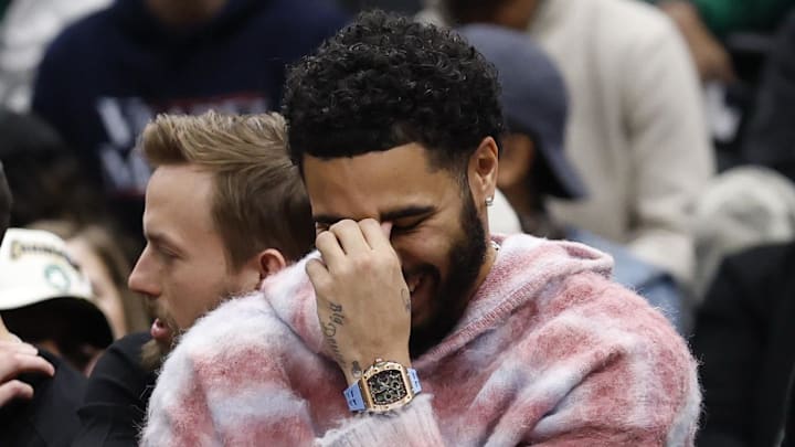 Dec 4, 2025; Washington, District of Columbia, USA; Injured Boston Celtics forward Jayson Tatum (L) reacts on the bench against the Washington Wizards in the second half at Capital One Arena. Mandatory Credit: Geoff Burke-Imagn Images