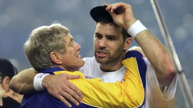 Rams quarterback Kurt Warner hugs head coach  Dick Vermeil following their Super Bowl victory.