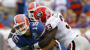 Oct 27, 2007; Jacksonville, FL, USA; Florida Gators quarterback Tim Tebow (15) is sacked by Georgia Bulldogs linebacker Dannell Ellerbe (33) and linebacker Marcus Washington (44) during the first quarter at Jacksonville Municipal Stadium in Jacksonville, Florida. Mandatory Credit: Jason Parkhurst-Imagn Images Copyright © 2007 Jason Parkhurst