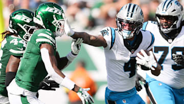 Oct 19, 2025; East Rutherford, New Jersey, USA; Carolina Panthers wide receiver Tetairoa McMillan (4) stiff arms New York Jets cornerback Sauce Gardner (1) in the second quarter at MetLife Stadium.