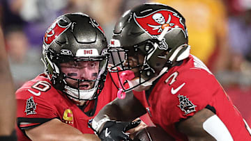 Oct 21, 2024; Tampa, Florida, USA; Tampa Bay Buccaneers quarterback Baker Mayfield (6) hands the ball off to running back Bucky Irving (7) against the Baltimore Ravens during the first quarter at Raymond James Stadium. Mandatory Credit: Kim Klement Neitzel-Imagn Images
