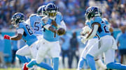 Tennessee Titans quarterback Cam Ward (1) hands off to running back Tony Pollard (20)