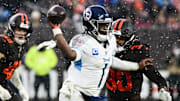 Tennessee Titans quarterback Cam Ward (1) throws a pass as Cleveland Browns linebacker Devin Bush (30) rushes during the fourth quarter at Huntington Bank Field