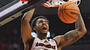 Jan 7, 2025; Louisville, Kentucky, USA; Louisville Cardinals forward James Scott (0) dunks against the Clemson Tigers during the second half at KFC Yum! Center. Louisville defeated Clemson 74-64