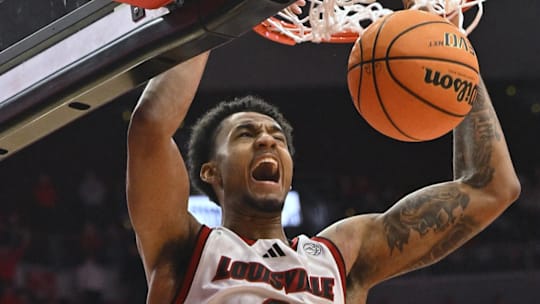 Jan 7, 2025; Louisville, Kentucky, USA; Louisville Cardinals forward James Scott (0) dunks against the Clemson Tigers during the second half at KFC Yum! Center. Louisville defeated Clemson 74-64