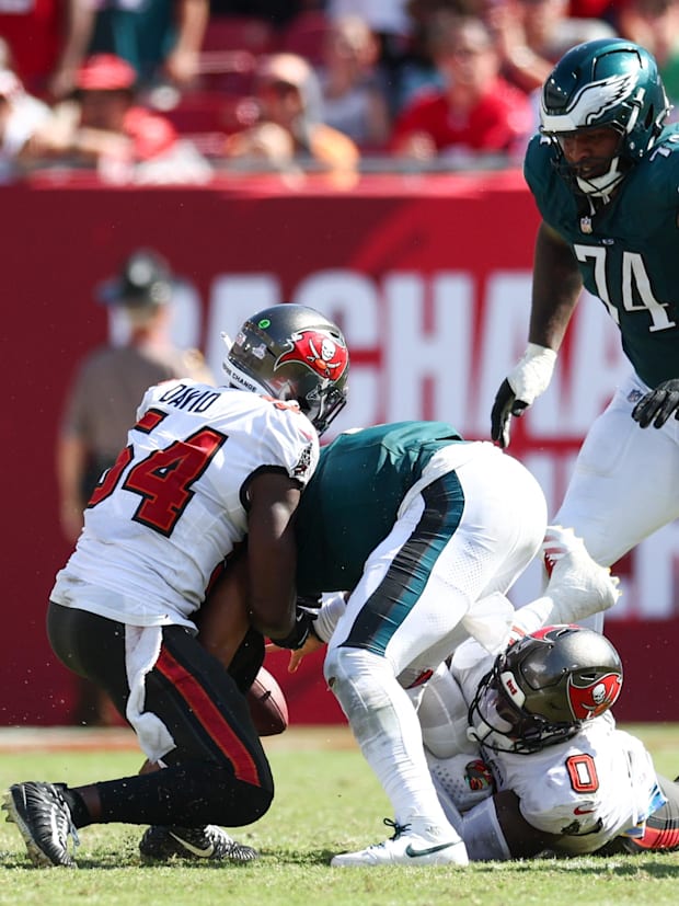 Tampa Bay Buccaneers linebacker Yaya Diaby and linebacker Lavonte David pressure Philadelphia Eagles quarterback Jalen Hurts.