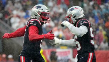 Matthew Judon and Josh Uche celebrate a first quarter sack against the Eagles.