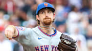 New York Mets pitcher Nolan McLean (26) throws to first base against the Atlanta Braves at Truist Park. 