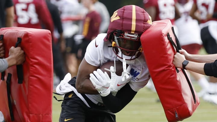 Jul 25, 2024; Ashburn, VA, USA; Washington Commanders wide receiver Jahan Dotson (1) carries the ball during day two of Commanders training camp at OrthoVirginia Training Center at Commanders Park. Mandatory Credit: Geoff Burke-USA TODAY Sports