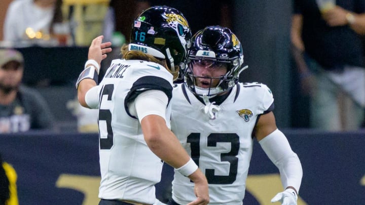 Oct 19, 2023; New Orleans, Louisiana, USA; Jacksonville Jaguars quarterback Trevor Lawrence (16) celebrates a  touchdown with wide receiver Christian Kirk (13) against the New Orleans Saints during the fourth quarter at the Caesars Superdome. Mandatory Credit: Matthew Hinton-USA TODAY Sports