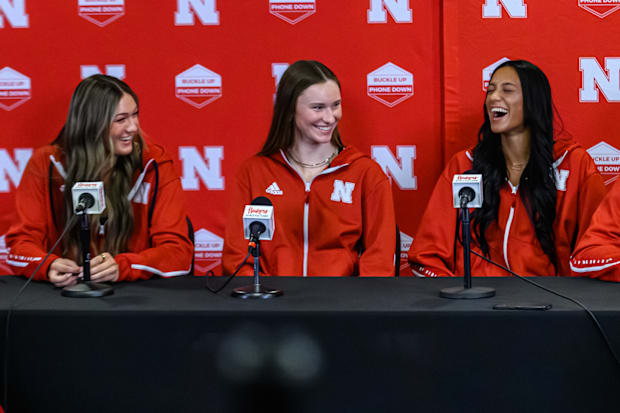 Andi Jackson, Bergen Reilly, and Harper Murray talk to the media. 