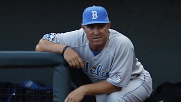 June 17, 2012; Omaha, NE, USA;  UCLA Bruins head coach John Savage watches from the dugout prior to the game against the Arizona Wildcats in six of the 2012 College World Series at TD Ameritrade Park. Mandatory Credit: Bruce Thorson-Imagn Images