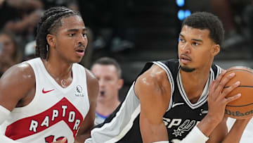 San Antonio Spurs forward/center Victor Wembanyama looks to pass in front of Toronto Raptors forward Collin Murray-Boyles.