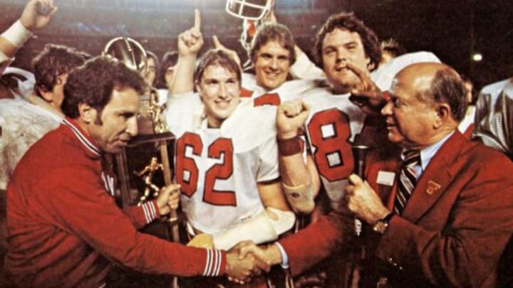 Indiana Lee Corso and some of the 1979 Hoosiers. including linebacker Terry Tallen (62), accept the Holiday Bowl trophy after the Hoosiers defeated Brigham Young 38-37. To this day, it's Indiana's only win inside the state of California.