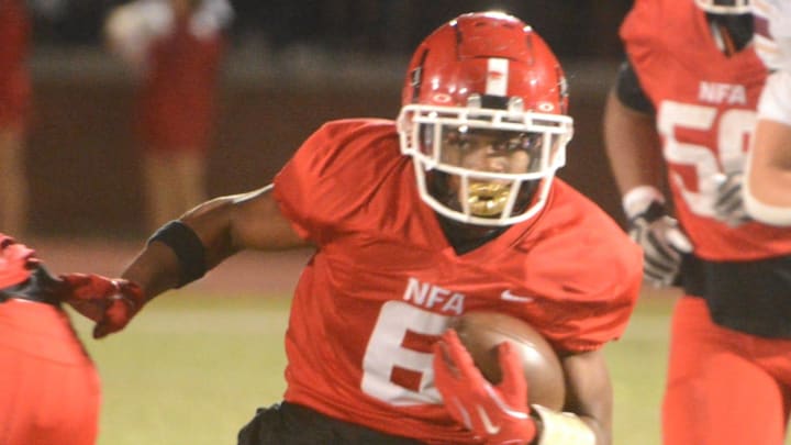NFA junior Luchen Lercius looks for some running room against Killingly on Friday night at Norwich.