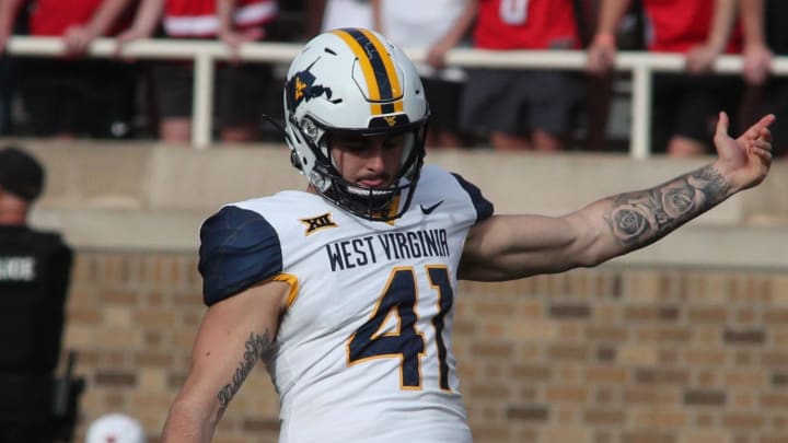 Oct 22, 2022; Lubbock, Texas, USA;  West Virginia Mountaineers punter Oliver Straw (41) punts against the Texas Tech Red Raiders in the second half at Jones AT&T Stadium and Cody Campbell Field. 