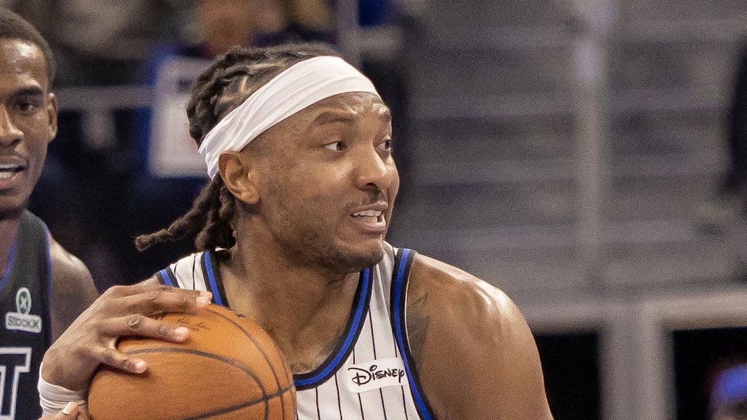 Orlando Magic center Wendell Carter Jr. hangs on to the ball between Detroit Pistons guard Ausar Thompson.