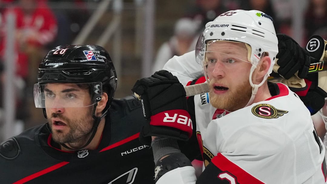 Apr 20, 2026; Raleigh, North Carolina, USA; Carolina Hurricanes left wing William Carrier (28) and Ottawa Senators defenseman Nikolas Matinpalo (33) battle during the third period in game two of the first round of the 2026 Stanley Cup Playoffs at Lenovo Center. Mandatory Credit: James Guillory-Imagn Images
