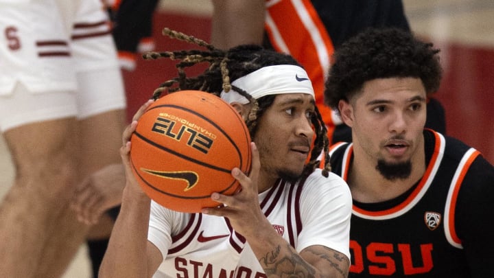 Feb 24, 2024; Stanford, California, USA; Stanford Cardinal guard Kanaan Carlyle (3) drives around Oregon State Beavers guard Jordan Pope (0) during the second half at Maples Pavilion. Mandatory Credit: D. Ross Cameron-USA TODAY Sports