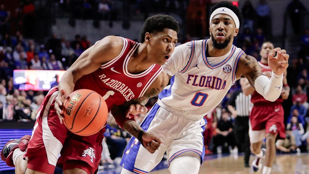 Arkansas guard Meleek Thomas (1) drives to the basket against Florida Gators guard Boogie Fland (0) during the first half at Exactech Arena at the Stephen C. O'Connell Center. 