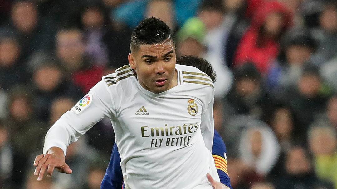 Casemiro, playing for Real Madrid, fights off Barcelona's Lionel Messi during the players' time in La Liga.