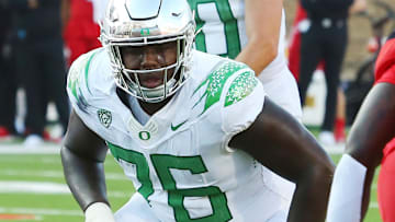 Sep 9, 2023; Lubbock, Texas, USA; Oregon Ducks offensive tackle Josh Conerly Jr. (76) prepares to block in the first half for quarterback Bo Nix (10) in the game against the Texas Tech Red Raiders at Jones AT&T Stadium and Cody Campbell Field. Mandatory Credit: Michael C. Johnson-Imagn Images