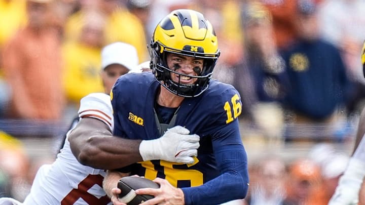 Michigan quarterback Davis Warren (16) is sacked by Texas linebacker Barryn Sorrell (88) during the second half at Michigan Stadium in Ann Arbor on Saturday, September 7, 2024.