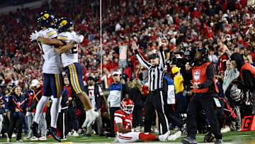 Jacob De Jesus (21) celebrates his game-winning catch at Louisville