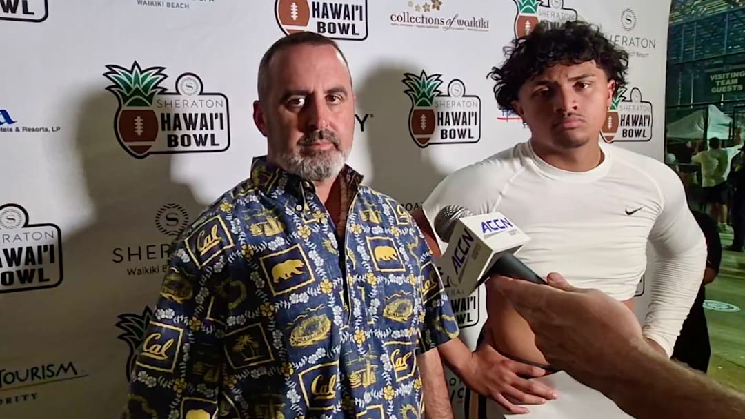 Nick Rolovich and Jaron-Keawe Sagapolutele in the post-game interview session