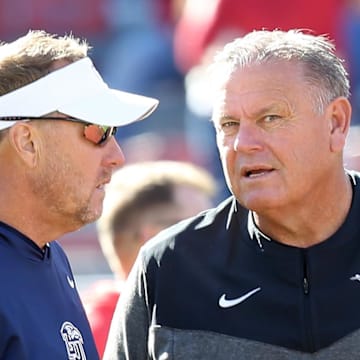  Liberty Flames head coach Hugh Freeze talks to Arkansas Razorbacks head coach Sam Pittman prior to the game at Donald W. Reynolds Razorback Stadium. 