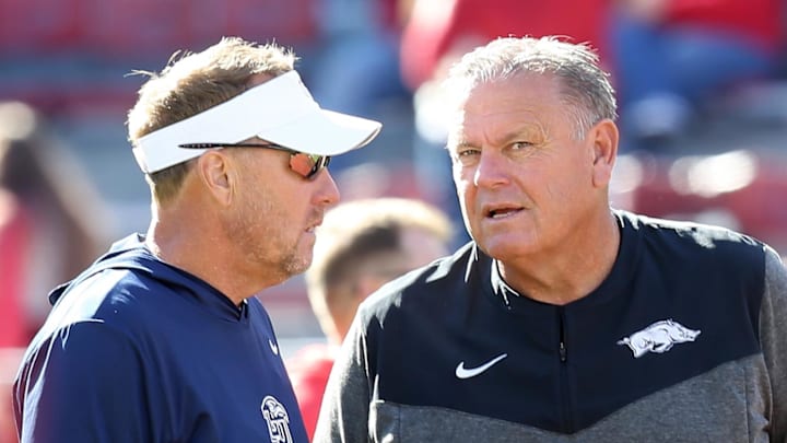  Liberty Flames head coach Hugh Freeze talks to Arkansas Razorbacks head coach Sam Pittman prior to the game at Donald W. Reynolds Razorback Stadium. 