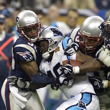 Feb 1, 2004; Houston, TX, USA; FILE PHOTO;  New England Patriots defensive back Tyrone Poole (38) and Richard Seymour (93) tackles Carolina Panthers running back Stephen Davis (48) as guard Jeno James (78) tries to block during Super Bowl XXXVIII at Reliant Stadium. The Patriots defeated the Panthers 32-29. Mandatory Credit: MPS-Imagn Images