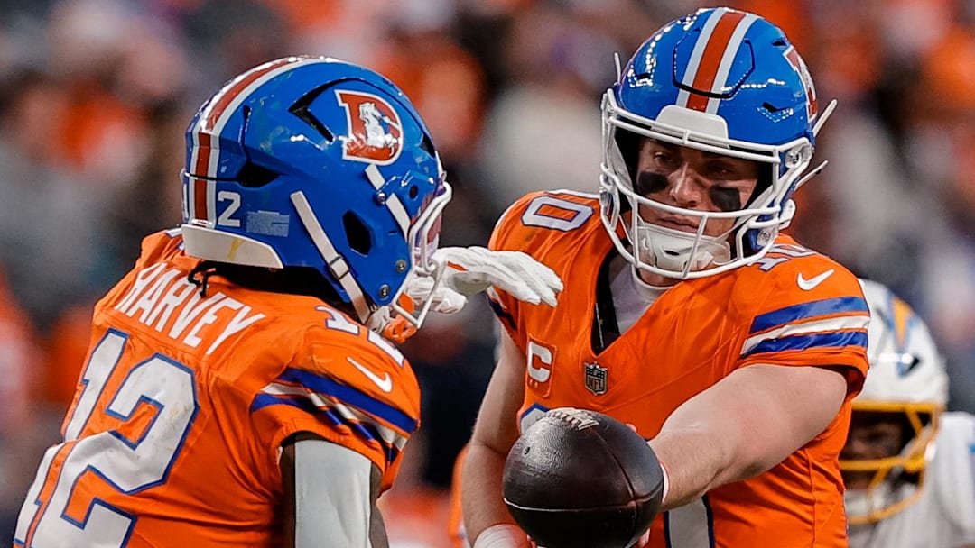 Jan 4, 2026; Denver, Colorado, USA; Denver Broncos quarterback Bo Nix (10) hands the ball off to running back RJ Harvey (12) in the third quarter against the Los Angeles Chargers at Empower Field at Mile High. Mandatory Credit: Isaiah J. Downing-Imagn Images