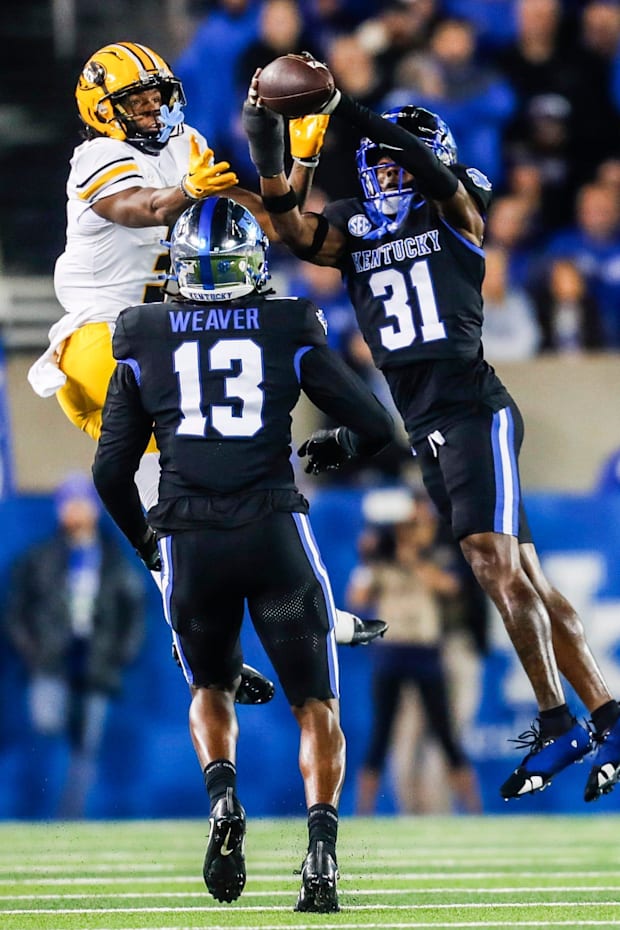 Kentucky Wildcats defensive back Maxwell Hairston intercepts a pass intended for Missouri Tigers wide receiver Luther Burden 