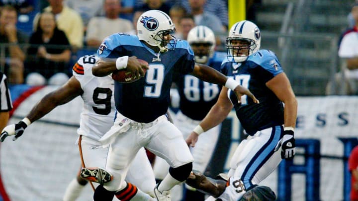 Tennessee Titans quarterback Steve McNair (9) jumps over Cleveland Browns defensive lineman Kenard Lang (96) during their preseason game at The Coliseum in Nashville on Aug. 9, 2003. The Titans came out on top 10-6.