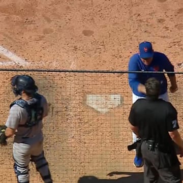 New York Mets manager Carlos Mendoza argues with umpire John Bacon after being ejected during a game against the New York Yankees.