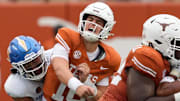 Sep 6, 2025; Austin, Texas, USA; Texas Longhorns quarterback Arch Manning (16) reacts after getting hit by San Jose State Spartans linebacker Taniela Latu (4) during the second half at Darrell K Royal-Texas Memorial Stadium.
