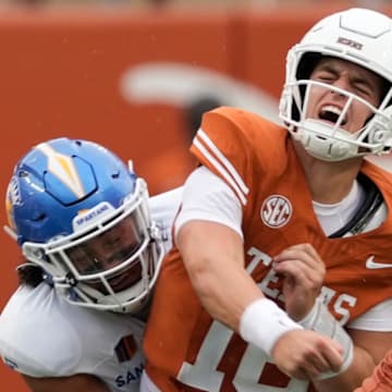 Sep 6, 2025; Austin, Texas, USA; Texas Longhorns quarterback Arch Manning (16) reacts after getting hit by San Jose State Spartans linebacker Taniela Latu (4) during the second half at Darrell K Royal-Texas Memorial Stadium.