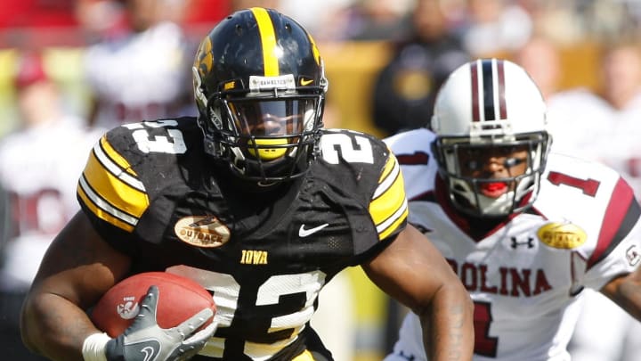 January 1, 2008; Tampa, FL, USA; Iowa running back Shonn Greene (23) runs past South Carolina cornerback Captain Munnerlyn during the second half of the Outback Bowl at Raymond James Stadium. Mandatory Credit: Kim Klement-USA TODAY Sports