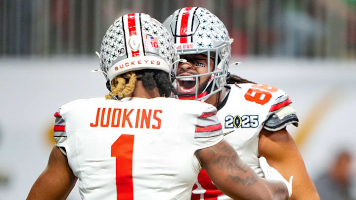 Ohio State running back Quinshon Judkins (left) celebrates with tight end Gee Scott Jr. during Monday's national title game.
