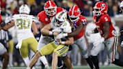 Georgia Bulldogs DT Tyrion Ingram-Dawkins and LB C.J. Allen tackle Georgia Tech Yellow Jackets QB Haynes King.
