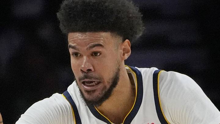Apr 23, 2026; Minneapolis, Minnesota, USA; Denver Nuggets forward Cameron Johnson (23) goes after the ball against the Minnesota Timberwolves in the third quarter at Target Center. Mandatory Credit: Bruce Kluckhohn-Imagn Images