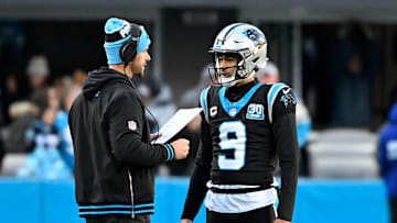 Dec 22, 2024; Charlotte, North Carolina, USA; Carolina Panthers head coach Dave Canales with quarterback Bryce Young (9) in the fourth quarter at Bank of America Stadium. 