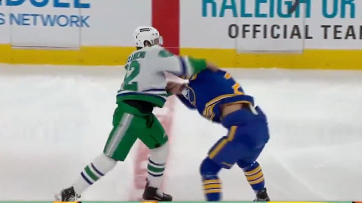 Carolina Hurricanes F Jesperi Kotkaniemi and Buffalo Sabres C Dylan Cozens fight during the first period. 