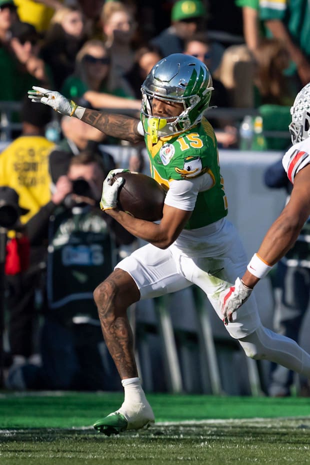 Oregon wide receiver Tez Johnson attempts to avoid a pack of Ohio State defenders