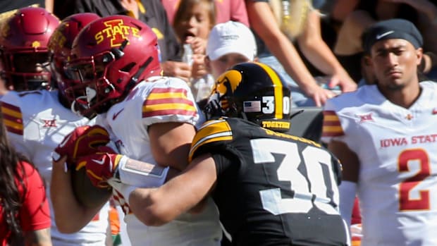 Iowa’s Quinn Schulte (30) pushes Iowa State’s Benjamin Brahmer (18) out of bounds during the CyHawk game Saturday, Sept. 7, 2