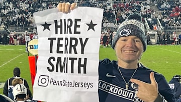 Penn State football fan Matt Wolosz holds up the "Hire Terry Smith" sign he printed for the Nittany Lions game vs. the Nebraska Cornhuskers.